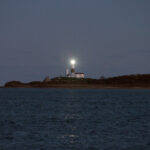 Lighted lighthouse from the water